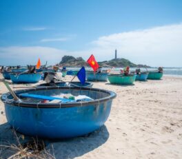 Des bateaux ronds, typiques du Vietnam, devant le phare de Ke Ga.